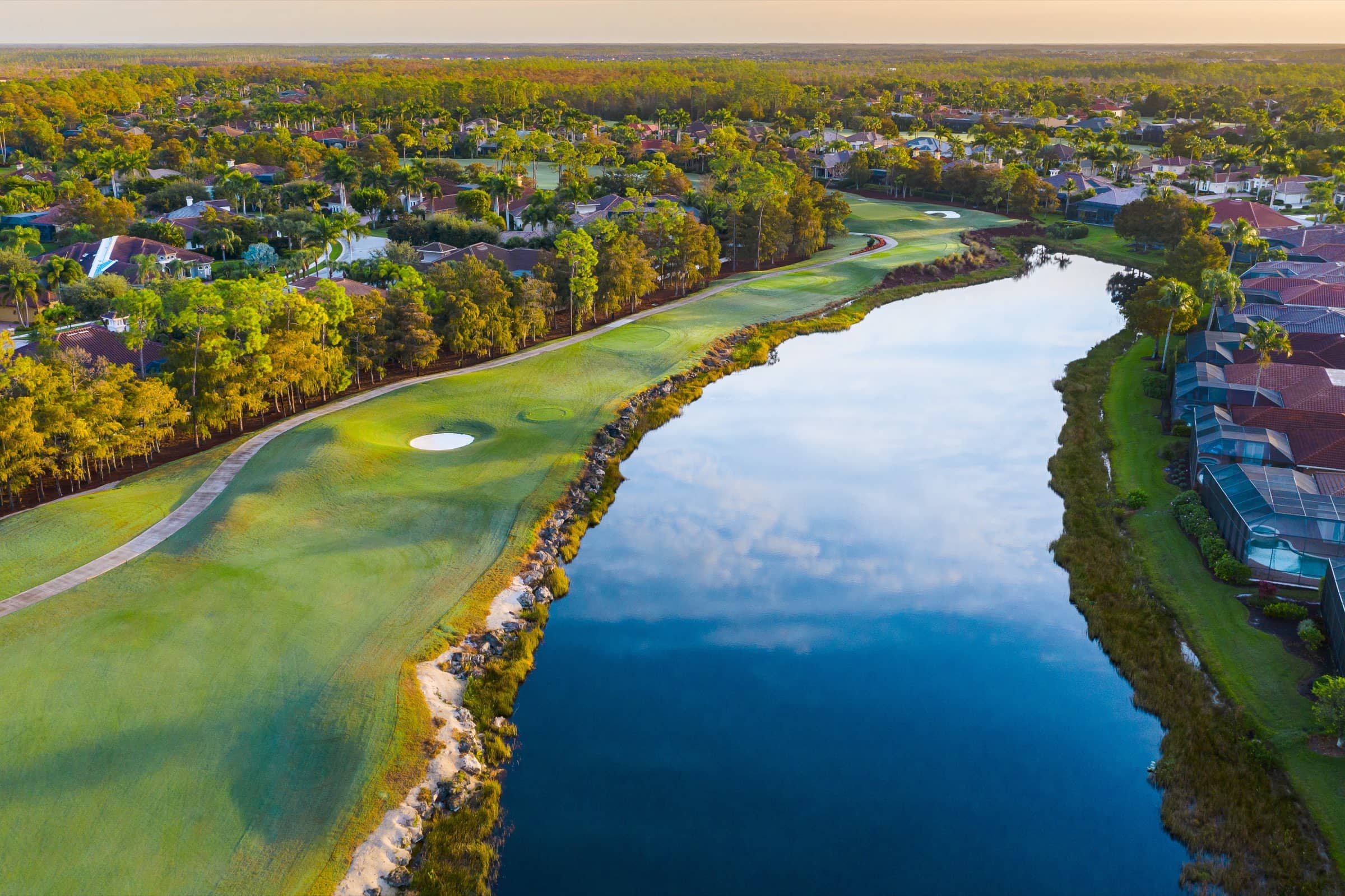 A fairway and lake at Olde Cypress from the air, with homes along the far bank