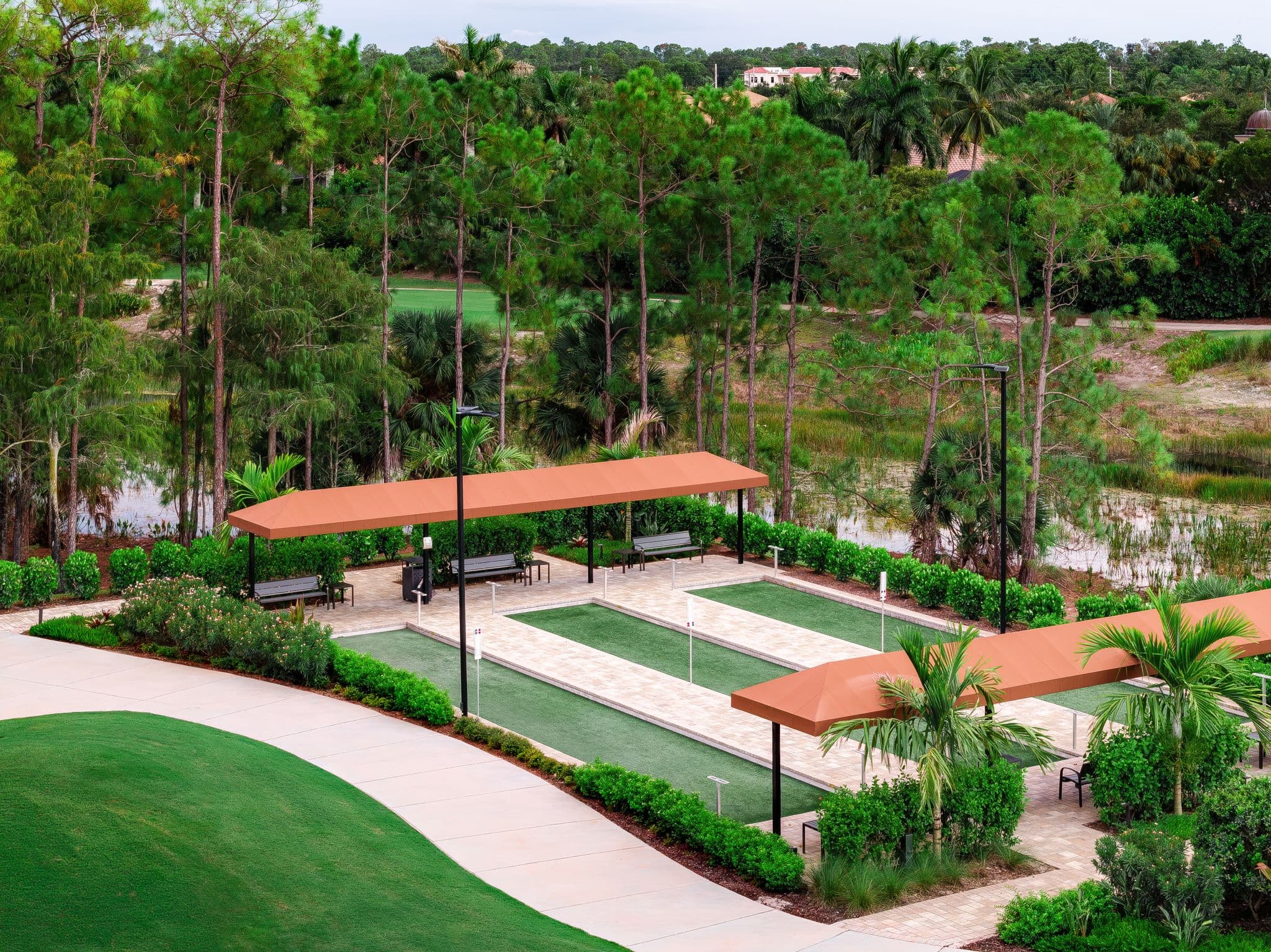 The bocce courts and their shade pavilions beside the course