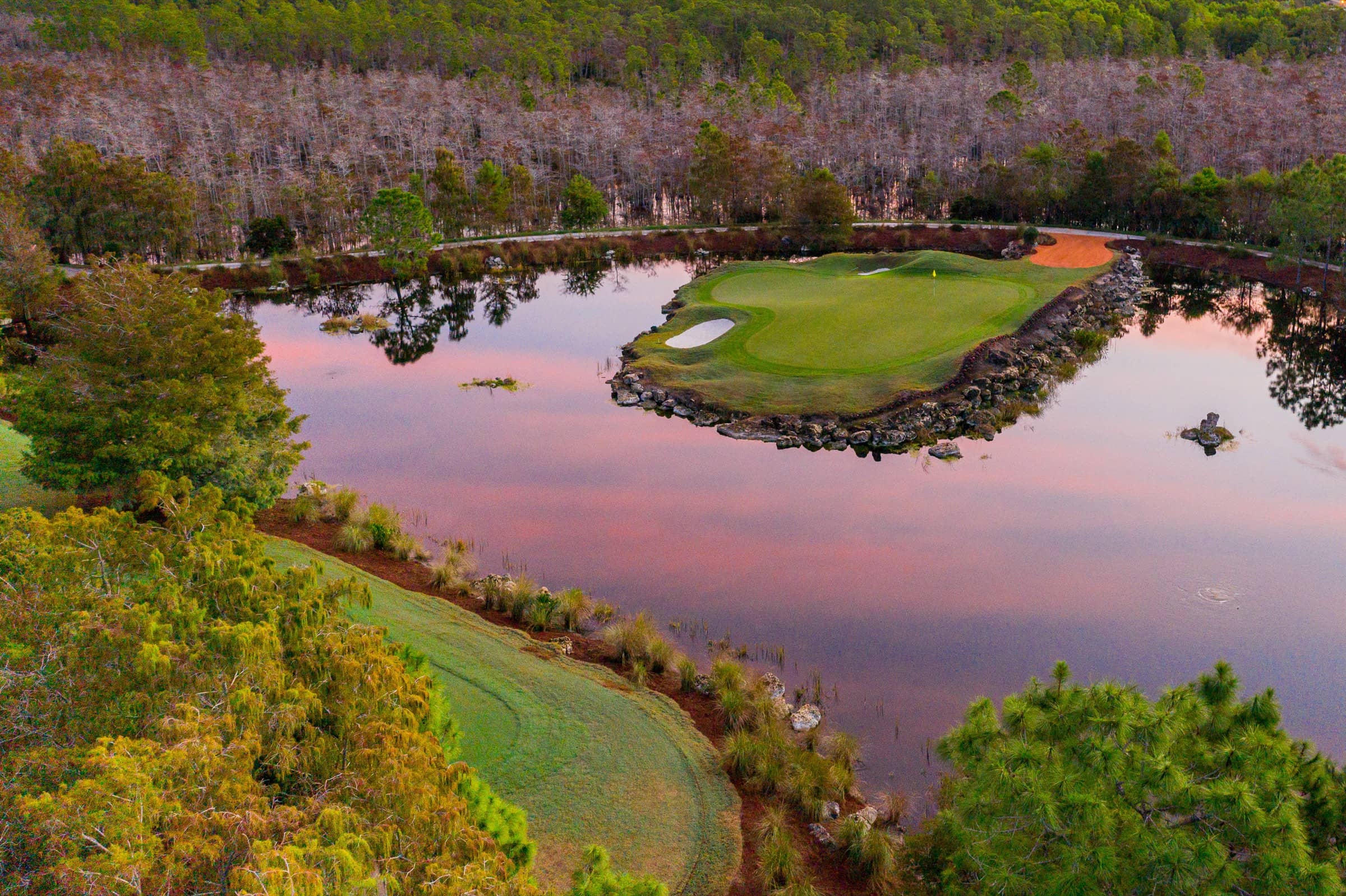 The island green on the 12th hole at Olde Cypress at dusk, seen from the air