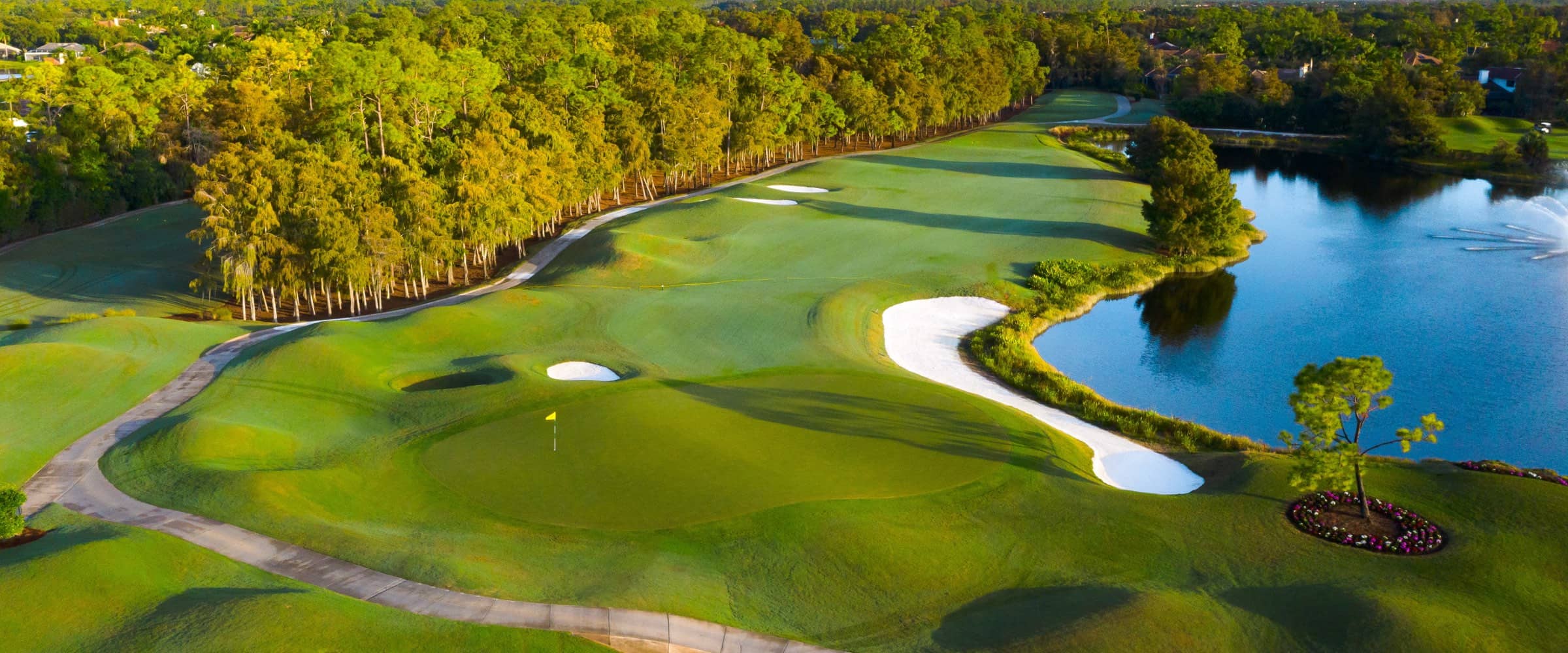 A fairway and lake at Olde Cypress in the morning, seen from the air